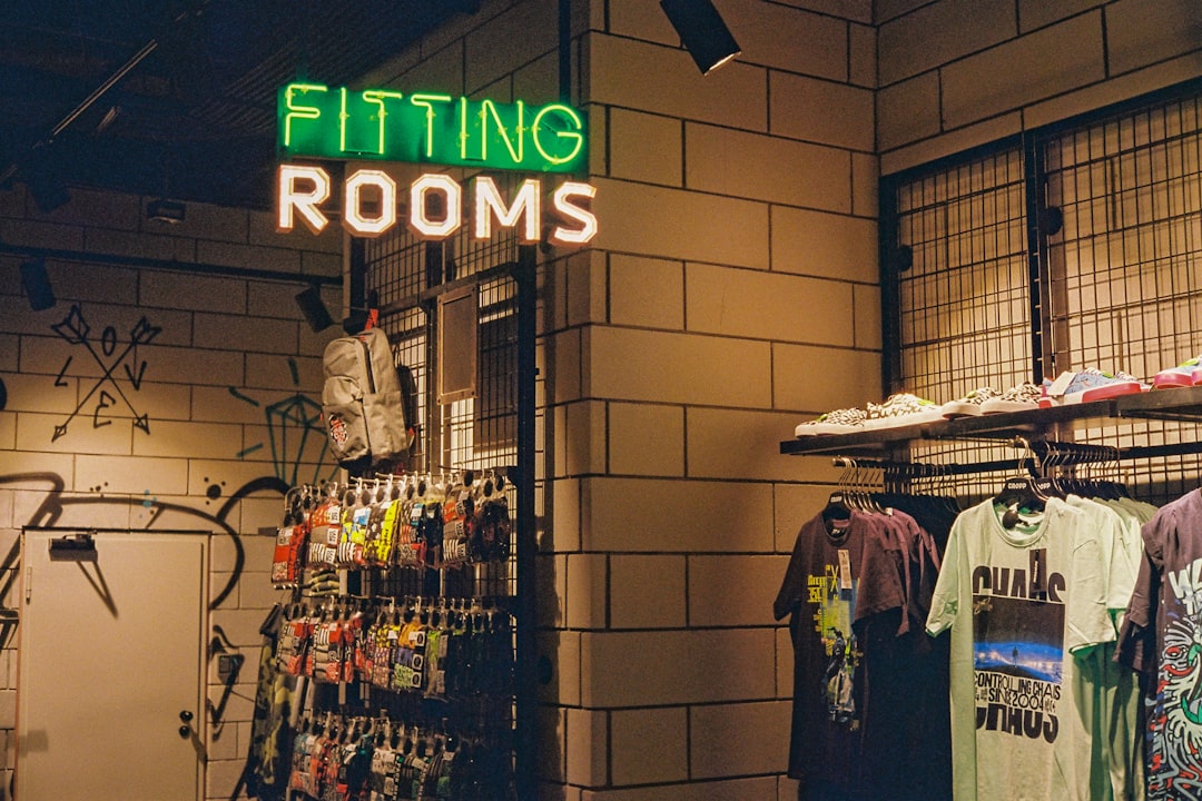 services-03 a-store-with-a-neon-sign-that-says-fitting-rooms-tsh8d8kutwu
