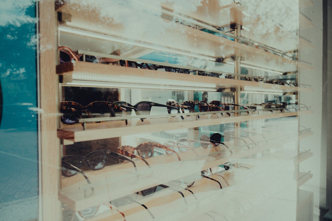 services-04 Showcase of stylish sunglasses in a retail window display, perfect for fashion and shopping themes.